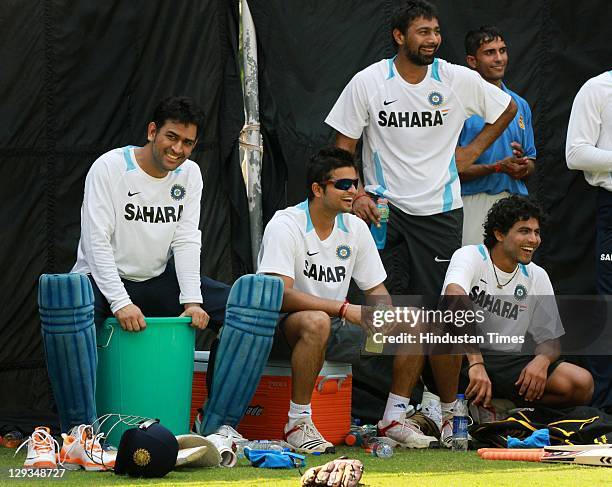 Indian Cricket team captain M S Dhoni, Suresh Raina, Praveen Kumar and Ravindra Jadeja share a light moment during the practice session at Ferozshah...