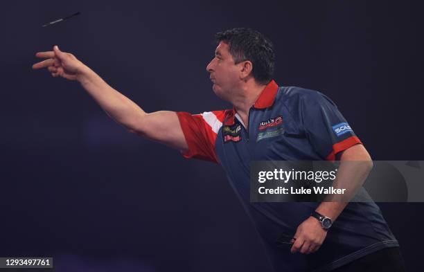 Mensur Suljović of Serbia in action during his third round match against Gary Anderson of Scotland during day eleven of the PDC William Hill World...