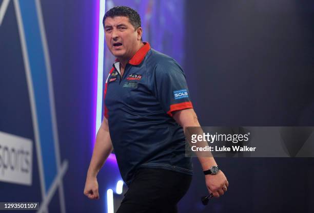 Mensur Suljović of Serbia reacts during his third round match against Gary Anderson of Scotland during day eleven of the PDC William Hill World Darts...