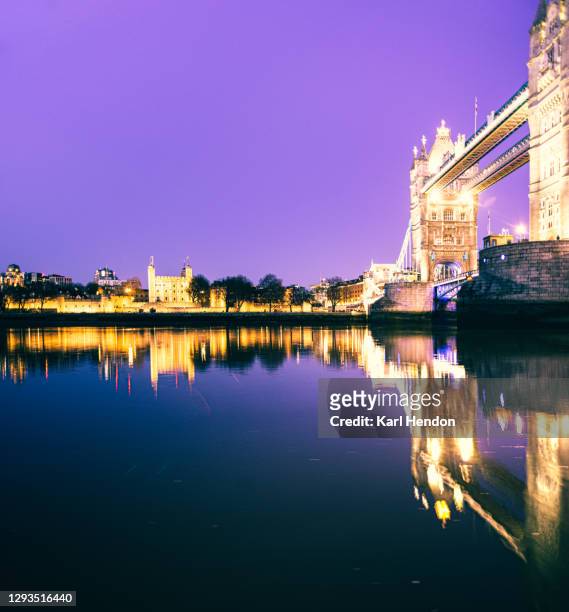 a night time view of london's tower bridge and the tower of london  - stock photo - london dawn stock pictures, royalty-free photos & images
