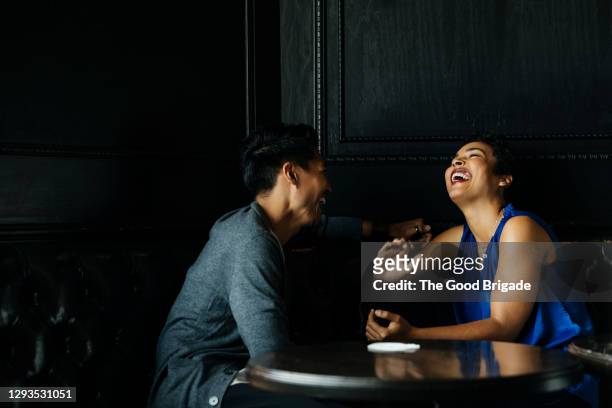 cheerful woman talking to male partner at restaurant - dating stock-fotos und bilder