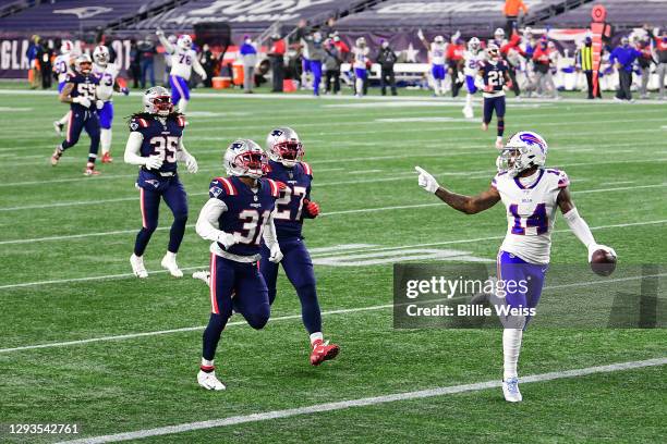 Stefon Diggs of the Buffalo Bills reacts as he runs into the end zone for a touchdown as Jonathan Jones and J.C. Jackson of the New England Patriots...