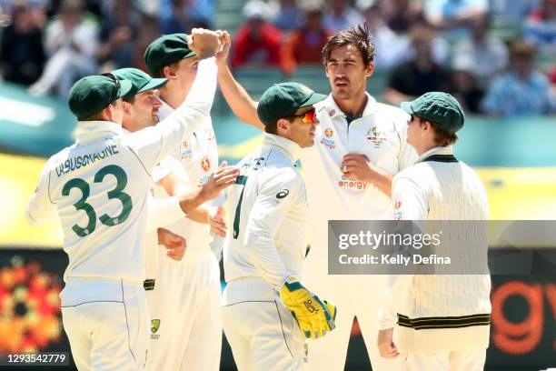 Mitchell Starc of Australia celebrates the dismissal of Mayank Agarwal of India during day four of the Second Test match between Australia and India...