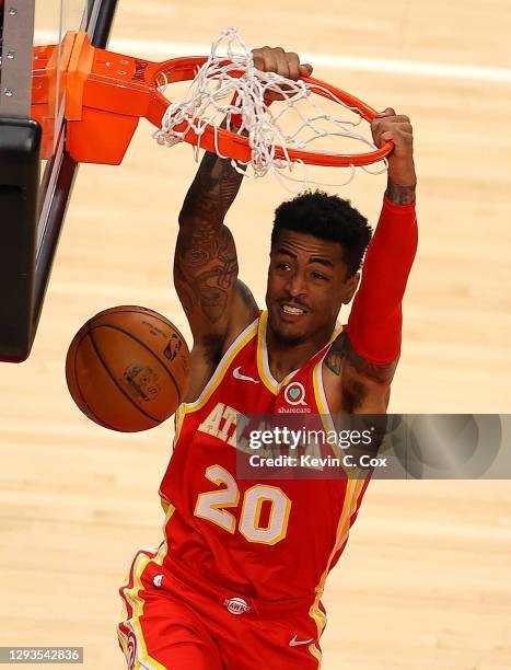 John Collins of the Atlanta Hawks dunks against the Detroit Pistons during the second half at State Farm Arena on December 28, 2020 in Atlanta,...