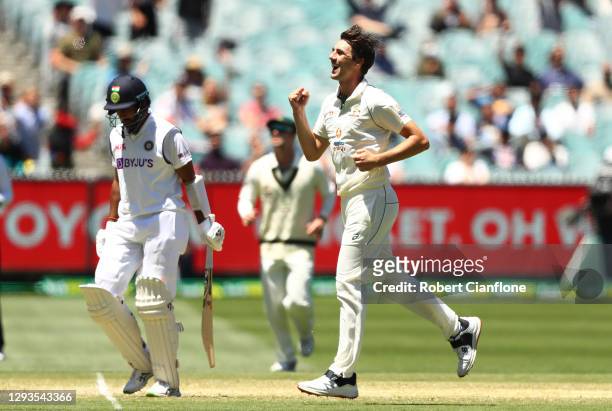 Pat Cummins of Australia celebrates taking the wicket of Cheteshwar Pujara of India during day four of the Second Test match between Australia and...