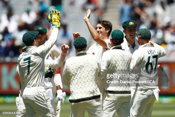 Pat Cummins of Australia celebrates the dismissal of Cheteshwar Pujara of India during day four of the Second Test match between Australia and India...