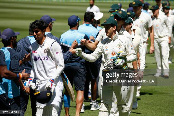 Players from both sides bump fists after day four of the Second Test match between Australia and India at Melbourne Cricket Ground on December 29,...