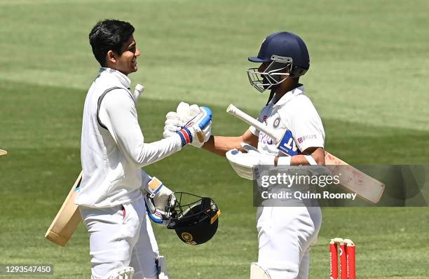 Shubman Gill and Ajinkya Rahane of India celebrate winning during day four of the Second Test match between Australia and India at Melbourne Cricket...