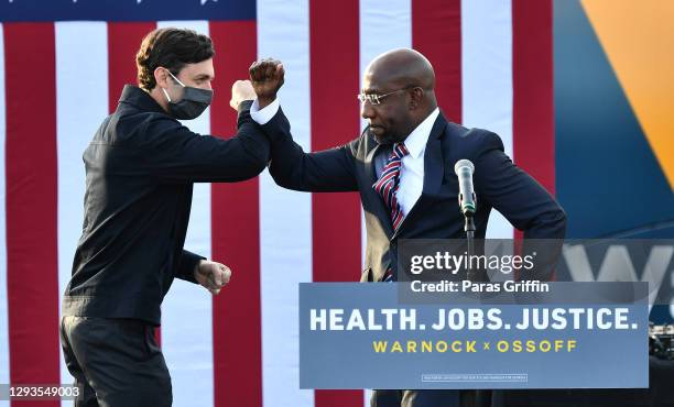 Georgia Democratic Senate candidates Jon Ossoff and Raphael Warnock greet each other onstage during the "Vote GA Blue" concert for Georgia Democratic...