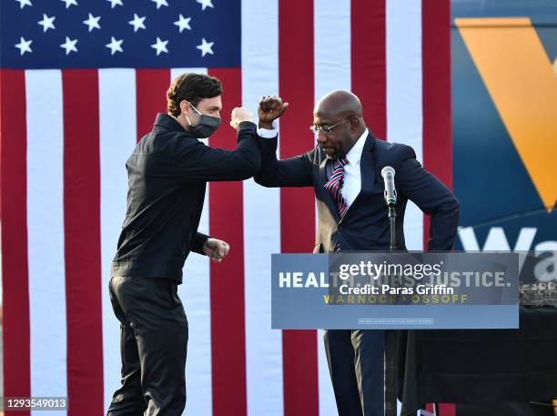 Georgia Democratic Senate candidates Jon Ossoff and Raphael Warnock greet each other onstage during the "Vote GA Blue" concert for Georgia Democratic...