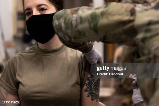 In this handout image provided by United States Forces Korea, U.S. Air Force senior airwoman Kassidy Peters receives a dose of the Moderna COVID-19...