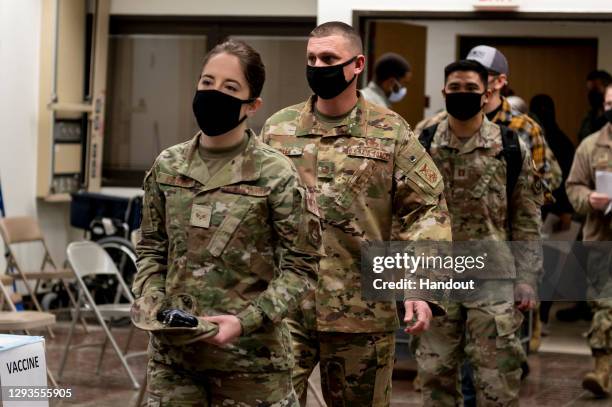 In this handout image provided by United States Forces Korea, Members of U.S. Air Force prepare to receive the first round of the Moderna COVID-19...