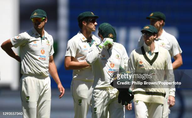 Tim Paine with his head down leads players from the field after India won the Second Test match between Australia and India at Melbourne Cricket...