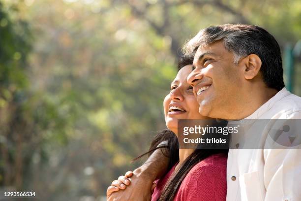 couple admiring view at park - mature indian couple stock pictures, royalty-free photos & images