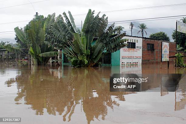 View of a flooded road in Ciudad Arce, 40 km west of San Salvador, El Salvador on October 16, 2011. According to Civil Protection authorities, 27...