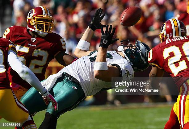 Tight end Brent Celek of the Philadelphia Eagles catches the ball in traffic against Rocky McIntosh and Oshiomogho Atogwe of the Washington Redskins...