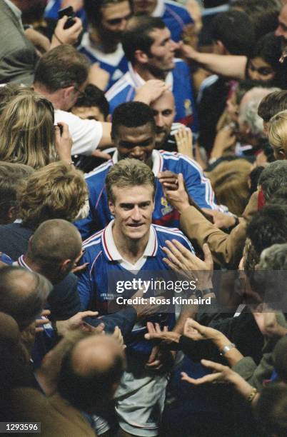 France captain Didier Deschamps leads his team up to the presentation box after victory in the World Cup Final against Brazil at the Stade de France...