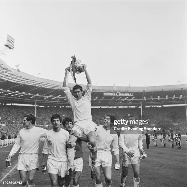 English footballer Mike Keen , captain of Queens Park Rangers FC, holds aloft the League Cup after the team won the Football League Cup Final against...