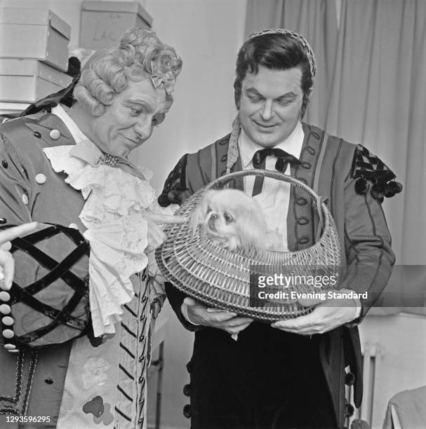 British opera singers Geraint Evans and Peter Glossop with a dog called Nina, UK, 20th March 1967. The two men are appearing as Doctor Bartolo and...