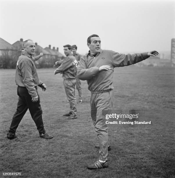 Bill Shankly , manager of Liverpool FC, watches team member Ian St John during a training session, UK, 27th January 1967.