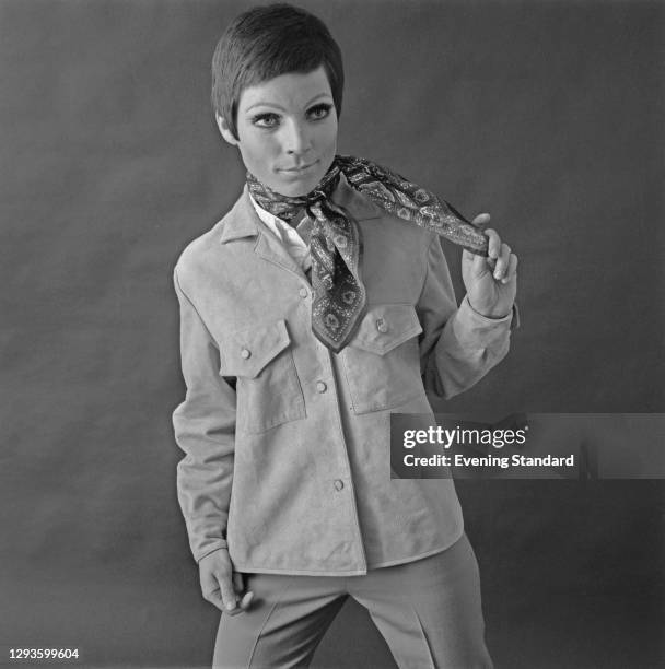 Model wearing a suede jacket and trousers with a patterned neckerchief, UK, April 1967.