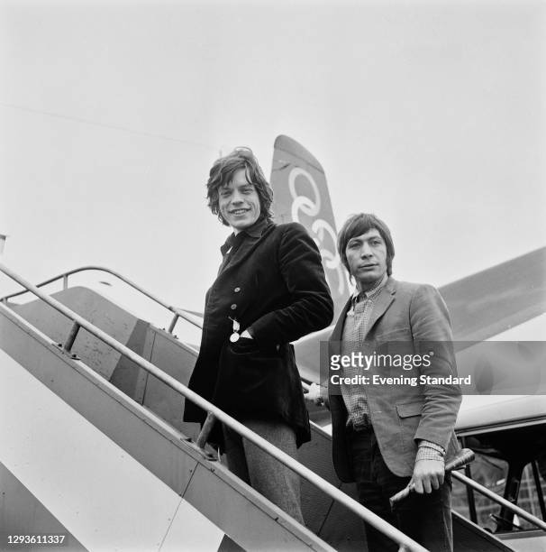 Singer Mick Jagger and drummer Charlie Watts of rock group the Rolling Stones at Heathrow Airport in London, UK, April 1967.