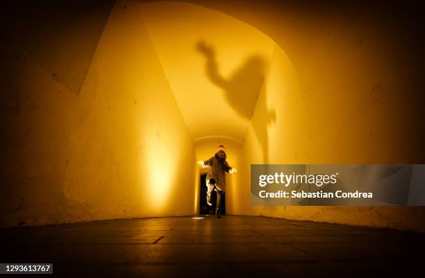 the shadow of the ghost girl in the tunnel, night lights, mystery and horror. - forsaken film stockfoto's en -beelden