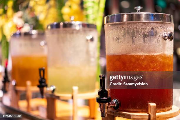 orange juice and other beverages in glass dispensers - change dispenser stock pictures, royalty-free photos & images