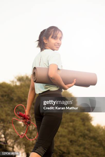 indian teenager girl doing skipping & exercise in park stock photo. - teenager meditating stock pictures, royalty-free photos & images