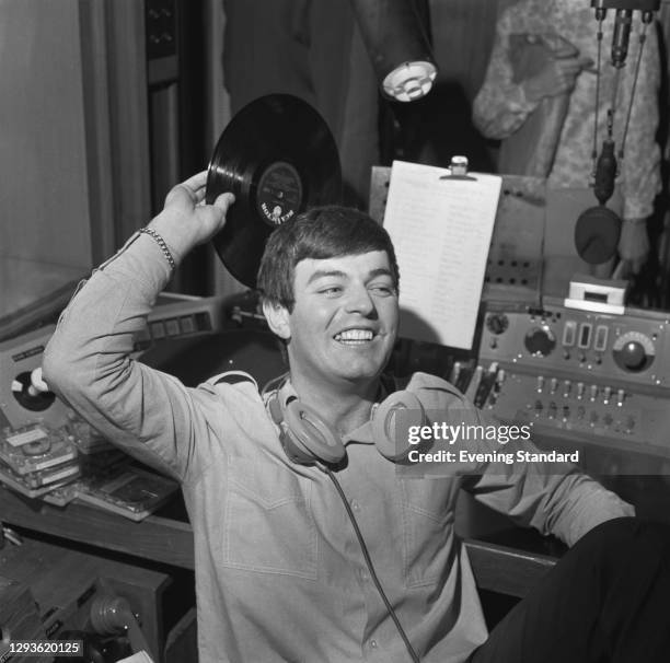 English disc jockey and singer Tony Blackburn becomes the first disc jockey to broadcast on the new BBC Radio 1, London, UK, 30th September 1967.