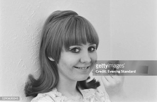 Scottish singer and actress Lulu eating with a spoon, UK, 1966.