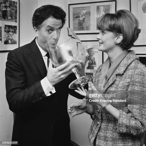 British actor-manager Brian Rix and his wife, Scottish actress Elspet Gray using an oversized brandy schooner, London, UK, March 1966.