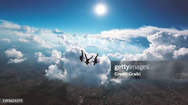 skydiving dramatic sky with blue background - fallen angel stock pictures, royalty-free photos & images