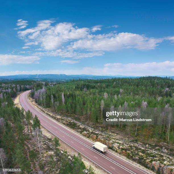 delivery truck on a highway through a forest - removal van stock pictures, royalty-free photos & images