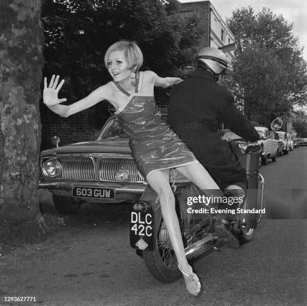 English model Twiggy wearing Bagatel autumn fashions - including this plastic disposable mini-dress, UK, 19th May 1966.