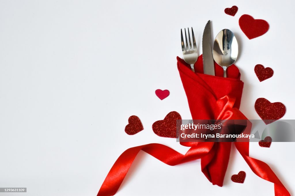 Day. table place setting and cutlery, napkin with red hearts for Valentine day. Holiday concept. Valentine's Day card. Menu for the valentine's Day.