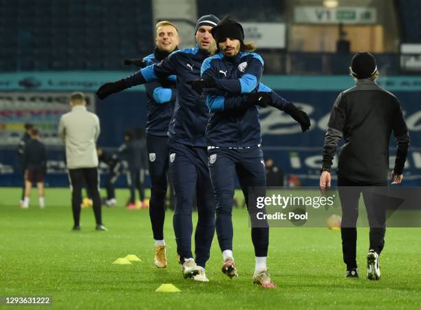 Filip Krovinovic, Branislav Ivanovic and Kamil Grosicki of West Bromwich Albion warm up prior to the Premier League match between West Bromwich...