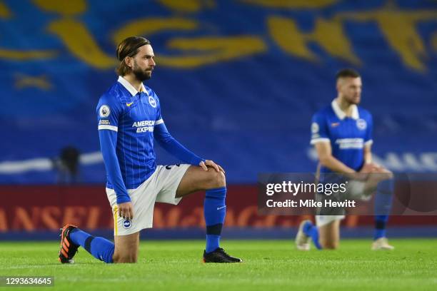 Davy Propper of Brighton & Hove Albion takes a knee in support of the 'Black Lives Matter' movement during the Premier League match between Brighton...