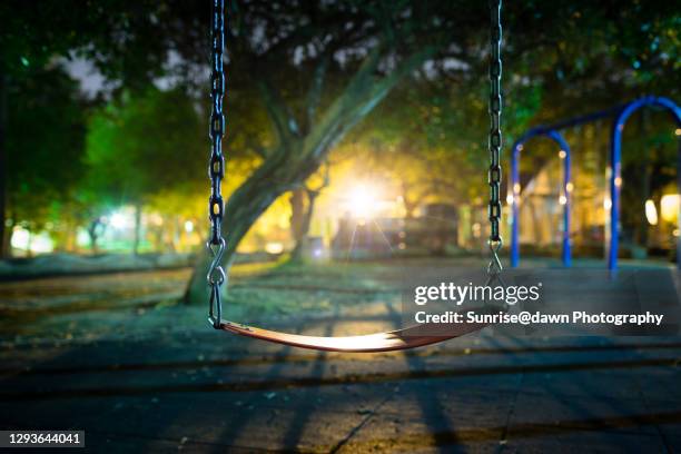 a park in the night - playground swing stock pictures, royalty-free photos & images