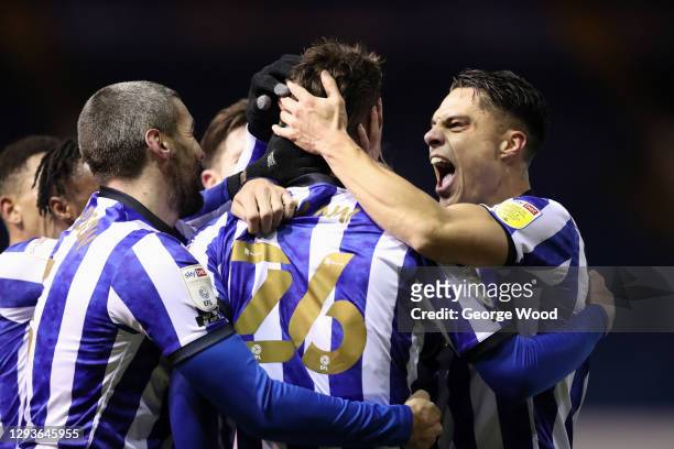 Liam Shaw of Sheffield Wednesday celebrates with teammates Callum Paterson and Joey Pelupessy after scoring his team's second goal during the Sky Bet...