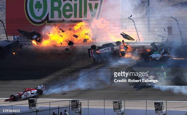The car of Dan Wheldon driver of the Bowers & Wilkins Sam Schmidt Motorsports Dallara Honda bursts into flames in a 15 car pile up including the Team...