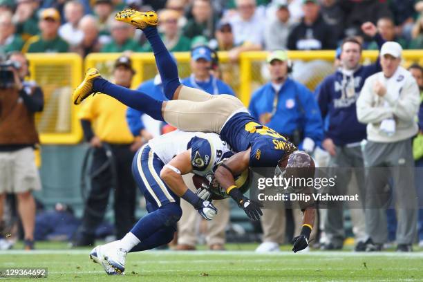 Tramon Williams of the Green Bay Packers tackles Greg Salas of the St. Louis Rams at Lambeau Field on October 16, 2011 in Green Bay, Wisconsin.