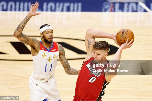Meyers Leonard of the Miami Heat is defended by Brandon Ingram of the New Orleans Pelicans during the second quarter at American Airlines Arena on...