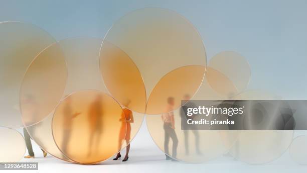 people standing behind glass circles - glass circle stock pictures, royalty-free photos & images