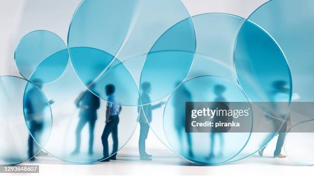 people behind blue glass circles - transparency concept stock pictures, royalty-free photos & images