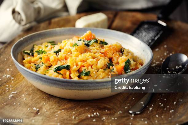 healthy vegan sweet potato spinach risotto with coconut cream - risotto stock pictures, royalty-free photos & images