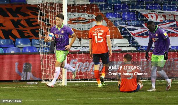 Chris Martin of Bristol City celebrates after his team's first goal, an own goal by Sonny Bradley of Luton Town who looks dejected during the Sky Bet...