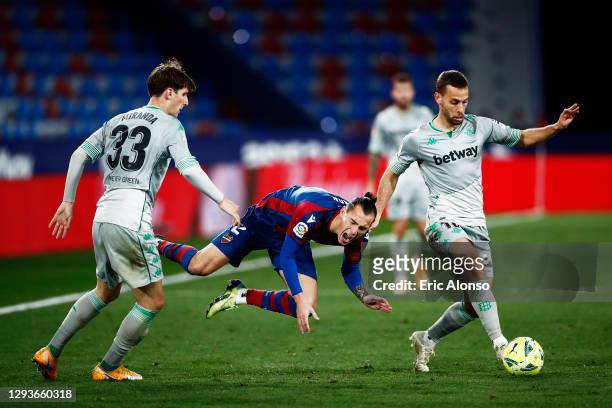 Son of Levante UD is challenged by Juan Miranda of Real Betis during the La Liga Santander match between Levante UD and Real Betis at Ciutat de...