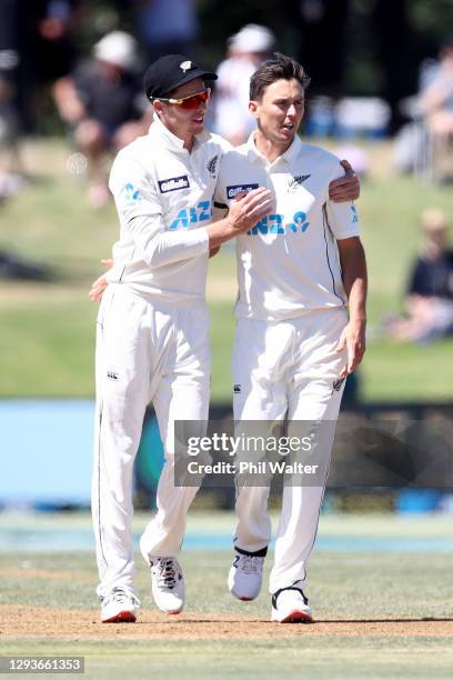 Mitchell Santner of New Zealand congratulates Trent Boult of New Zealand on his wicket of Azhar Ali of Pakistan during day five of the First Test...