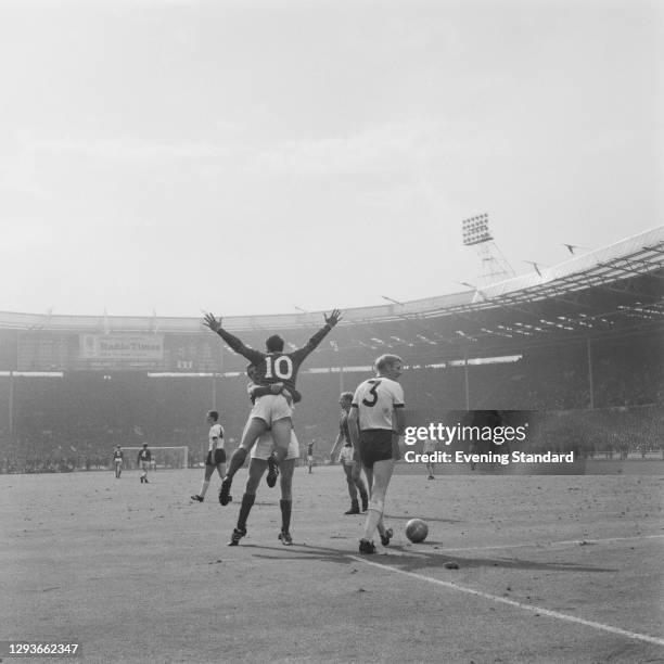 England footballer Geoff Hurst being hugged by a team-mate at Wembley Stadium in London, during the World Cup Final between England and West Germany,...